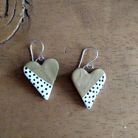 Heart shaped dangle clay earrings painted half gold and half white with black spots 